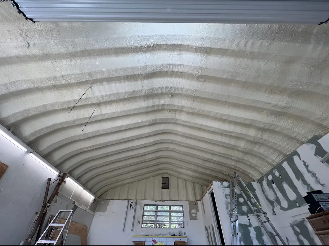 Spray polyurethane foam applied to the underside of a metal roof deck in Easton